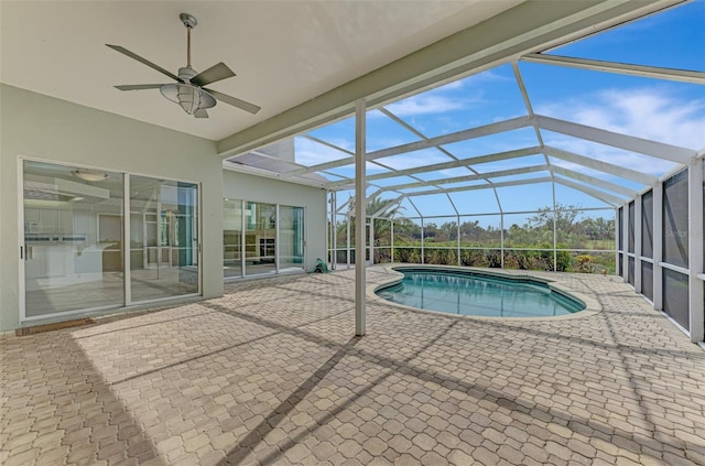 view of pool with a patio, a lanai, and ceiling fan