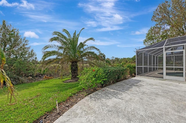 view of yard with glass enclosure