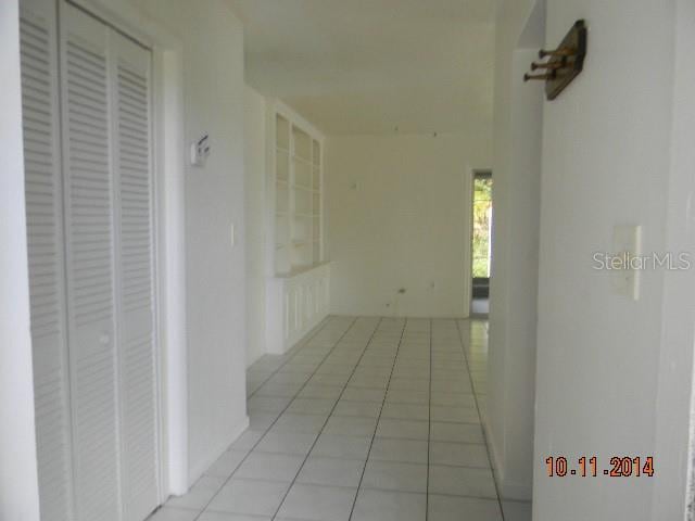 corridor featuring light tile patterned flooring