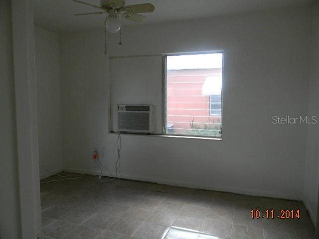 unfurnished room featuring ceiling fan