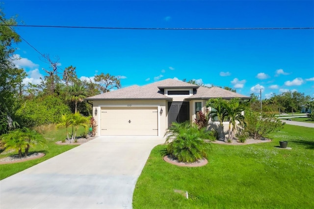 view of front of property featuring a front yard and a garage