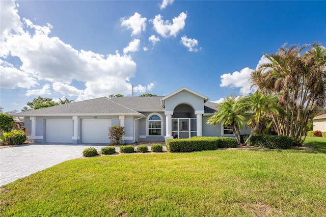 ranch-style house featuring a front yard and a garage