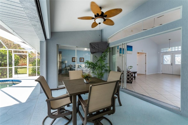 tiled dining space with lofted ceiling, french doors, and ceiling fan