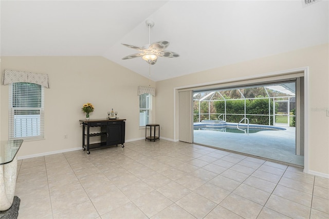 unfurnished living room featuring ceiling fan, light tile patterned flooring, and lofted ceiling