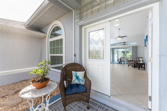 view of exterior entry with ceiling fan