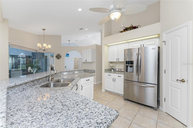 kitchen with sink, hanging light fixtures, white cabinets, light tile patterned floors, and stainless steel refrigerator with ice dispenser