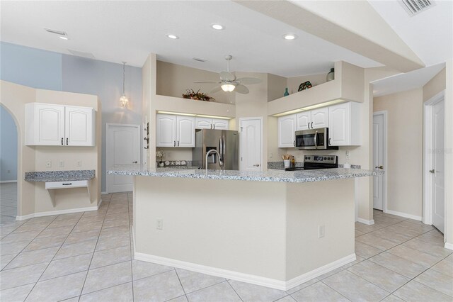 110 Abercrombie Ave, Englewood, FL 34223 - kitchen featuring appliances with stainless steel finishes, ceiling fan, light tile patterned flooring, white cabinetry, and high vaulted ceiling