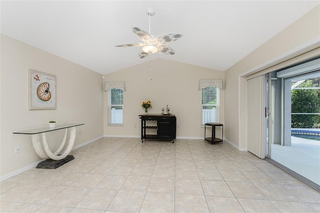 interior space with ceiling fan, light tile patterned flooring, lofted ceiling, and a swimming pool