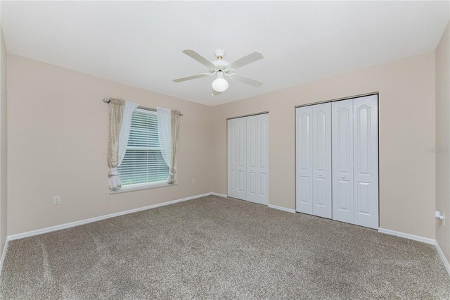 110 Abercrombie Ave, Englewood, FL 34223 - unfurnished bedroom with multiple closets, carpet, baseboards, and a ceiling fan
