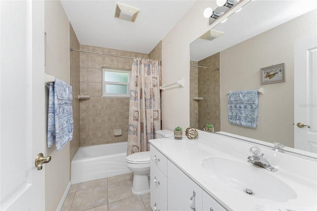 full bathroom with a textured ceiling, toilet, shower / bath combo with shower curtain, vanity, and tile patterned flooring