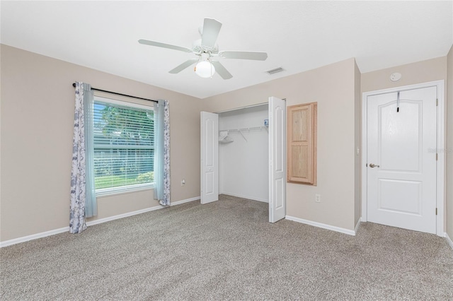 unfurnished bedroom with light colored carpet, a closet, and ceiling fan