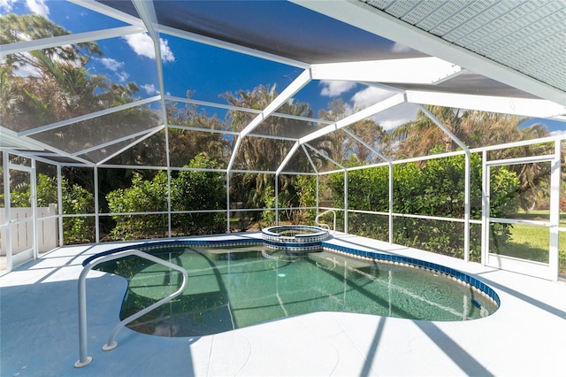 view of swimming pool featuring an in ground hot tub, a patio, and a lanai