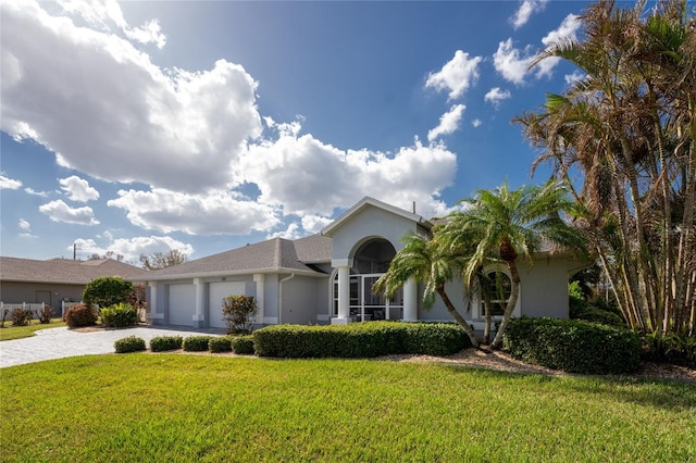 view of front of home with a front yard and a garage