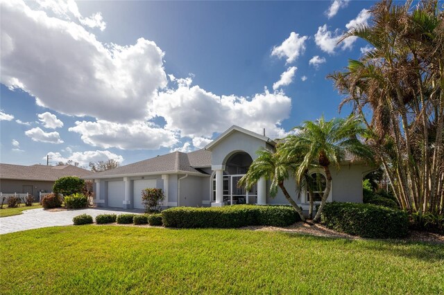 110 Abercrombie Ave, Englewood, FL 34223 - single story home featuring stucco siding, decorative driveway, an attached garage, and a front yard