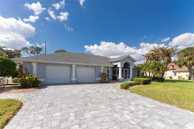 view of front facade featuring a front yard and a garage