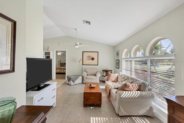 living room featuring vaulted ceiling, ceiling fan, and light hardwood / wood-style flooring