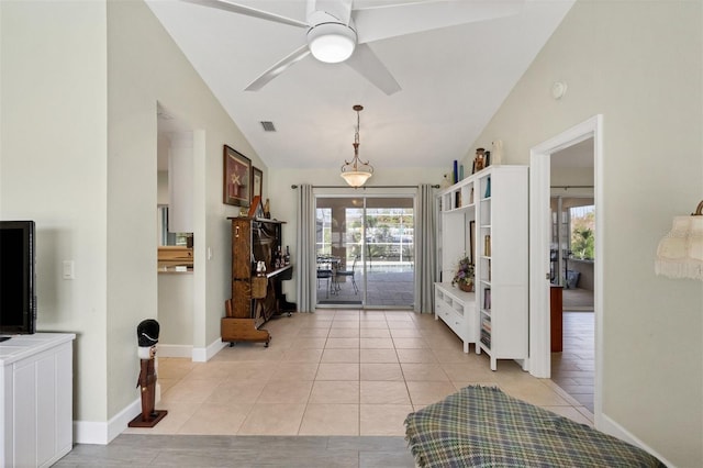 tiled foyer entrance featuring ceiling fan and vaulted ceiling