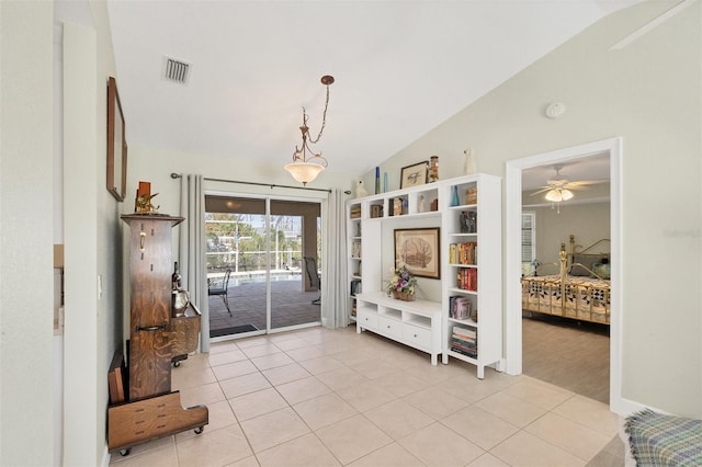 interior space featuring light tile patterned floors and vaulted ceiling