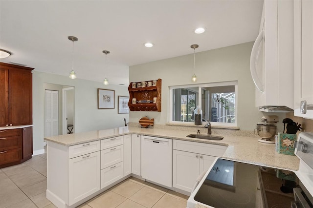 kitchen featuring kitchen peninsula, sink, decorative light fixtures, and white dishwasher