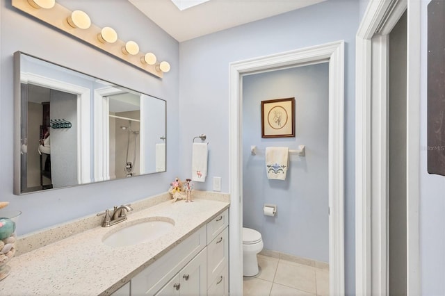 bathroom featuring tile patterned floors, toilet, a skylight, vanity, and a shower with shower curtain