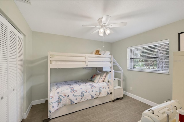 bedroom featuring ceiling fan, hardwood / wood-style floors, and a closet