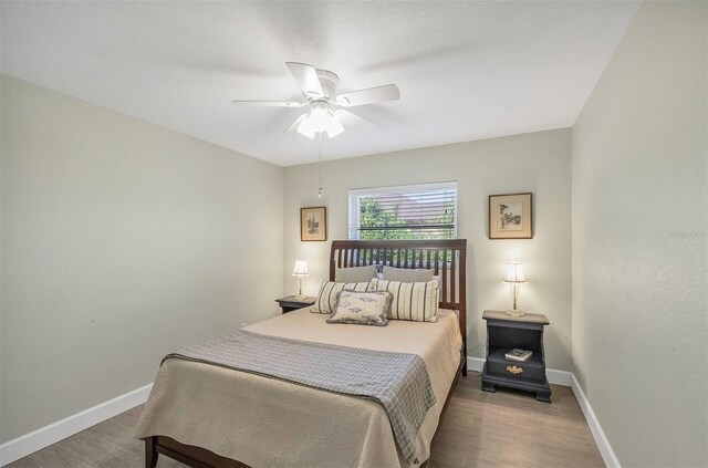 bedroom with ceiling fan and hardwood / wood-style flooring