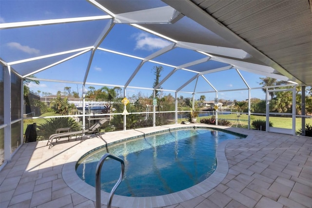 view of swimming pool with glass enclosure and a patio area