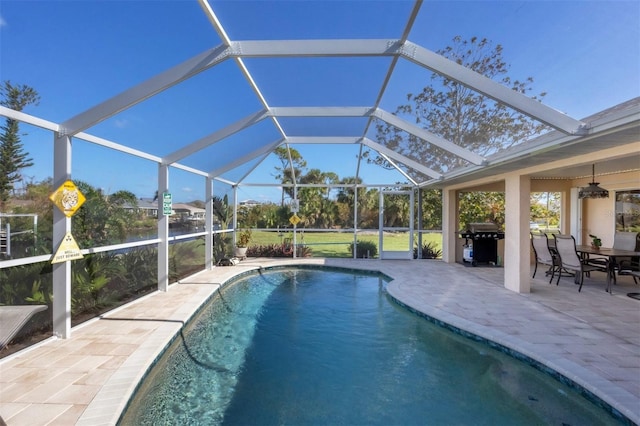 view of swimming pool with a patio area, a lanai, and a grill