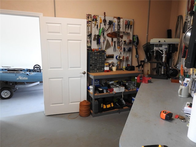 miscellaneous room with a workshop area and concrete flooring