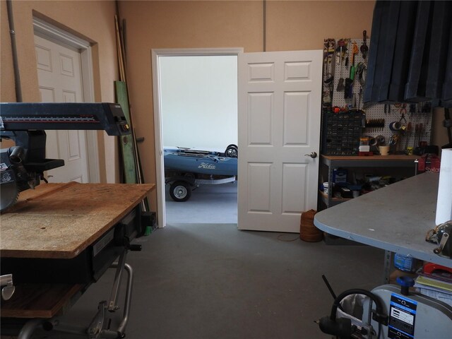 miscellaneous room with a workshop area and concrete flooring