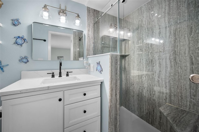 bathroom with a shower with door and vanity