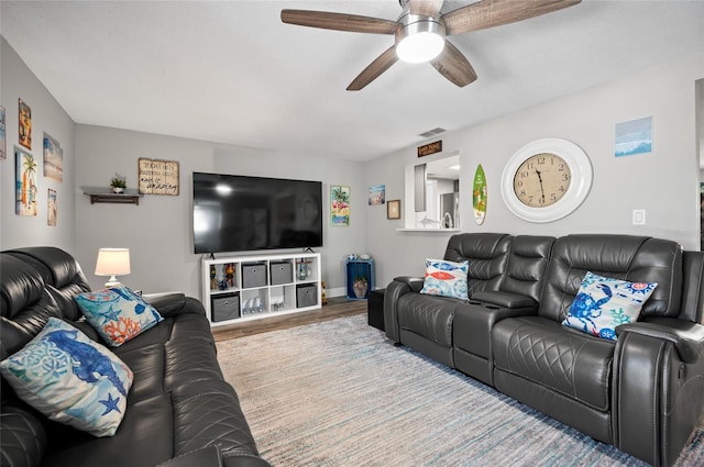 living room with hardwood / wood-style flooring and ceiling fan