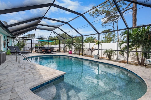 view of swimming pool with a patio and glass enclosure