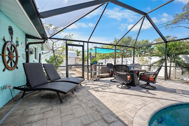 view of patio / terrace with glass enclosure and a pool