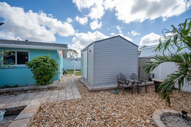 exterior space featuring a shed and a patio area