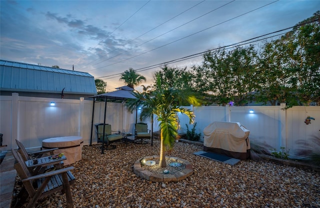 yard at dusk with a gazebo