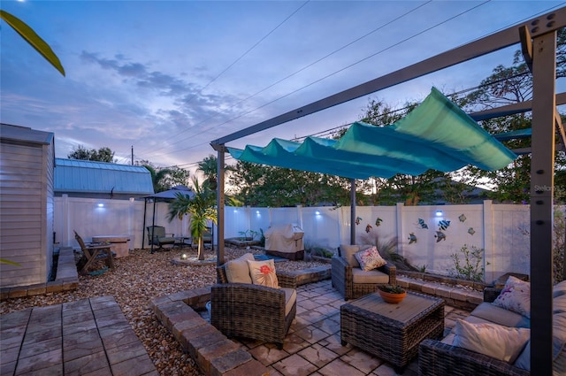 patio terrace at dusk featuring outdoor lounge area