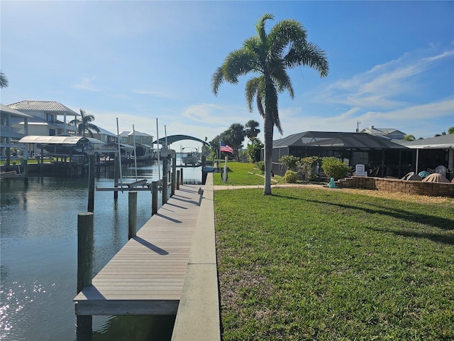 view of dock featuring a lanai, a yard, and a water view