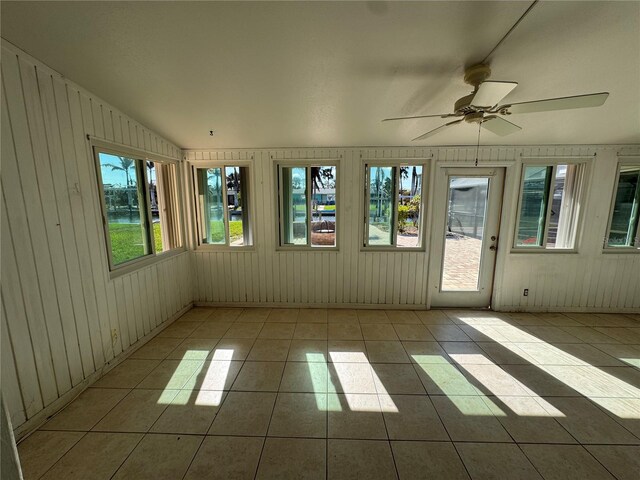 unfurnished sunroom with ceiling fan