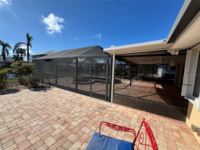 view of patio / terrace featuring glass enclosure