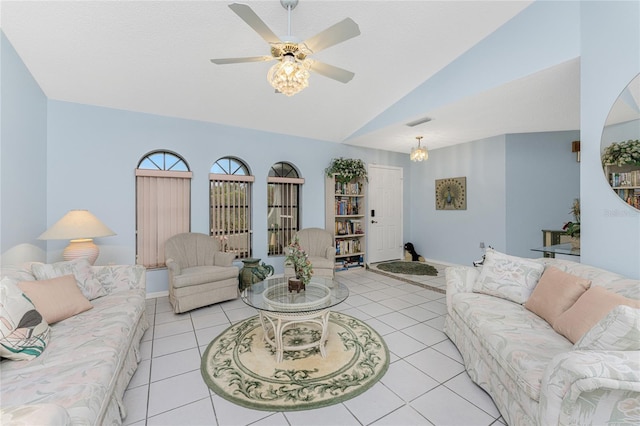 tiled living room featuring ceiling fan with notable chandelier and lofted ceiling