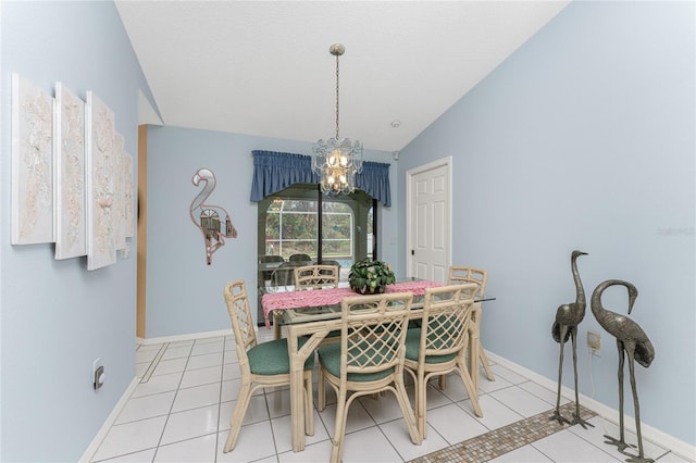 tiled dining room with a chandelier and lofted ceiling