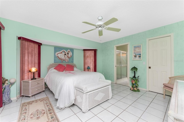 tiled bedroom featuring a textured ceiling and ceiling fan