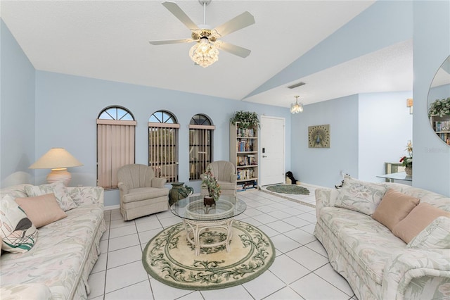 living room with ceiling fan, vaulted ceiling, and light tile patterned flooring