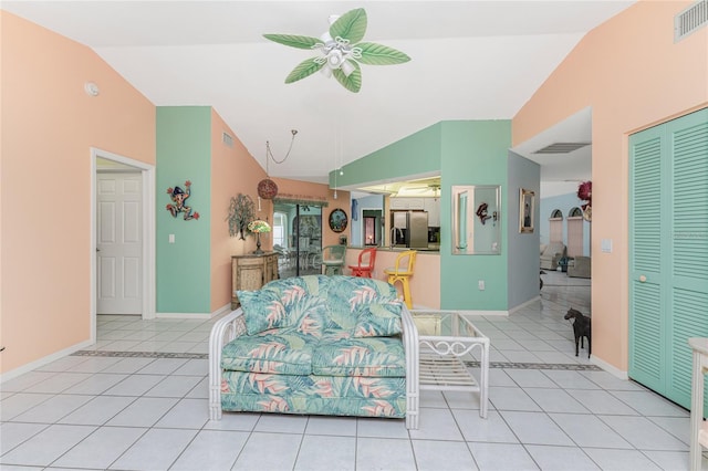 living room with light tile patterned flooring, lofted ceiling, and ceiling fan