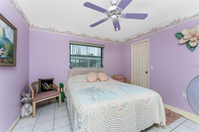 tiled bedroom with a textured ceiling and ceiling fan