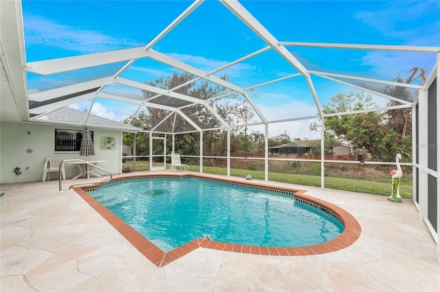 view of swimming pool featuring a patio and a lanai