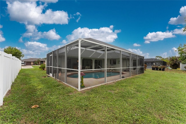 view of swimming pool with a lawn and a lanai