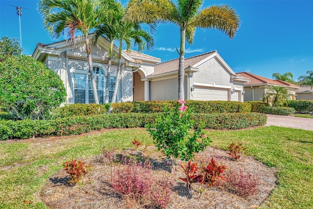 view of front of property featuring a garage and a front yard