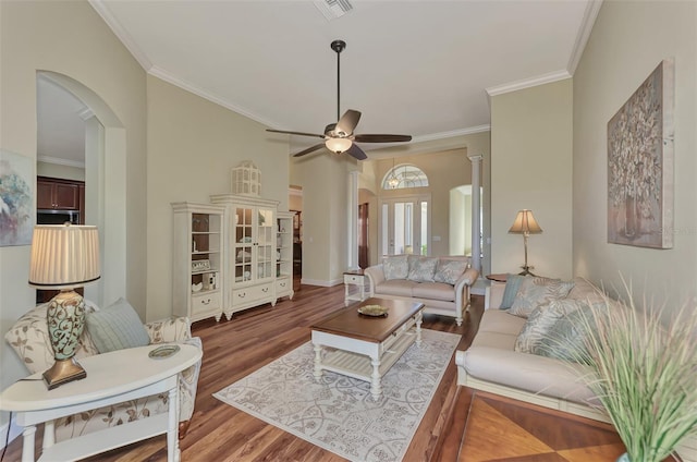 living room with hardwood / wood-style flooring, crown molding, and ceiling fan